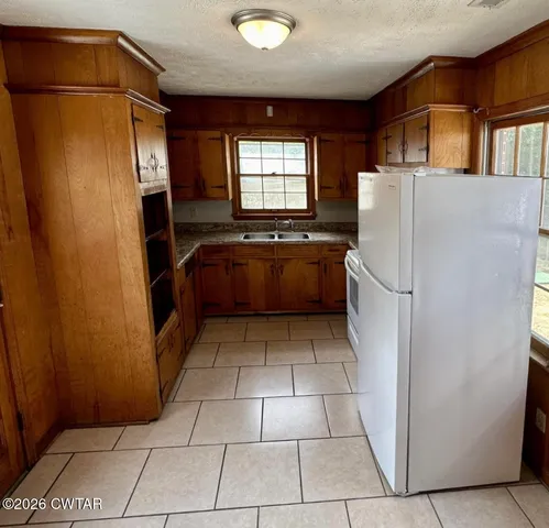 a kitchen with a refrigerator and a sink
