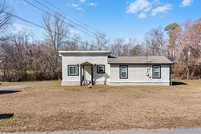 a house that has a tree in front of it