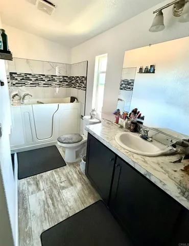 a bathroom with a sink toilet and mirror