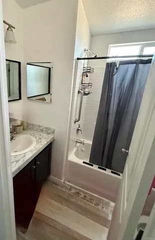 a bathroom with a granite countertop sink and a mirror