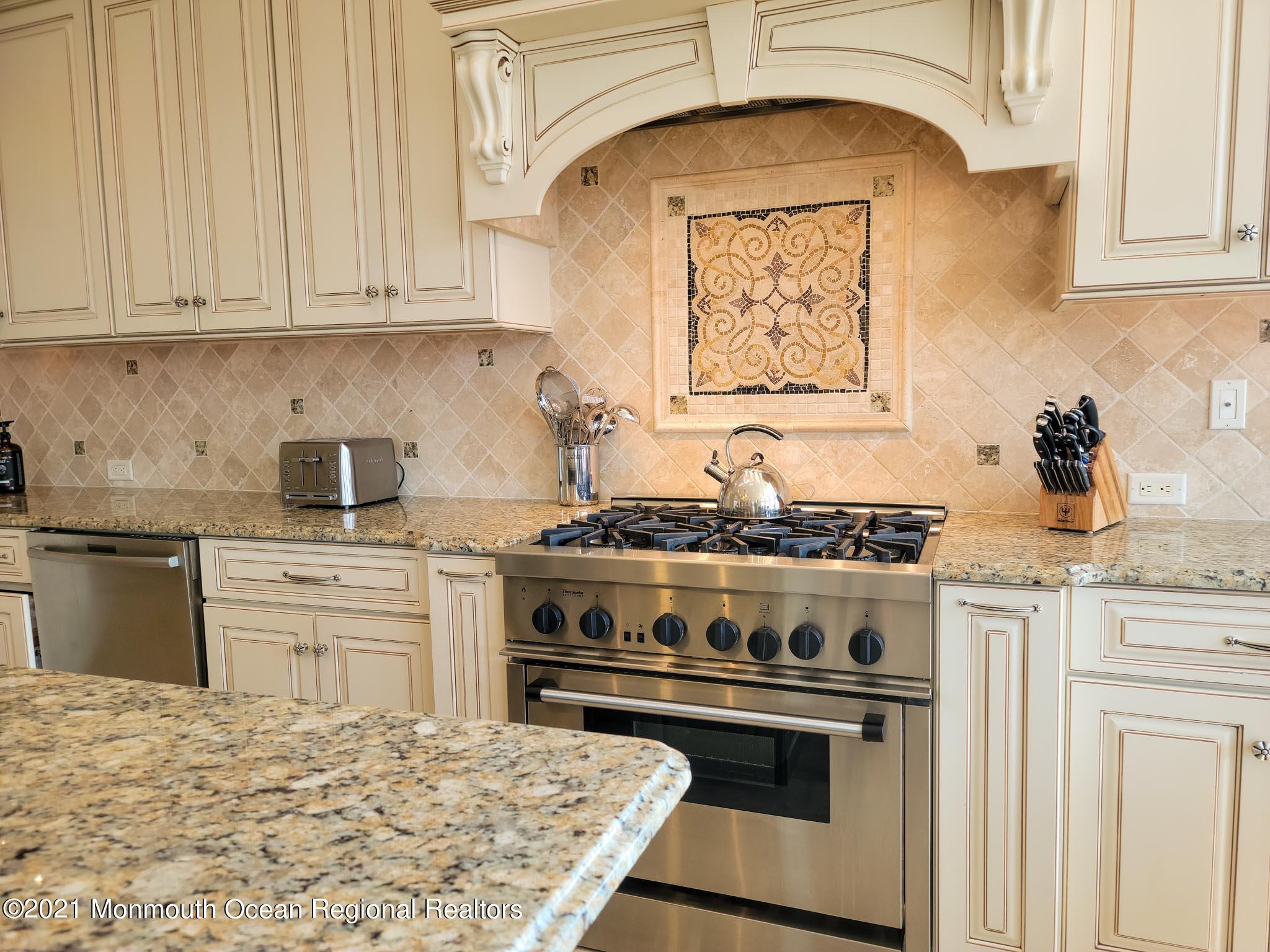 203 Ketch Road Mantoloking, NJ 08738 - Photo 26 of 88 a kitchen with stainless steel appliances granite countertop a stove and white cabinets