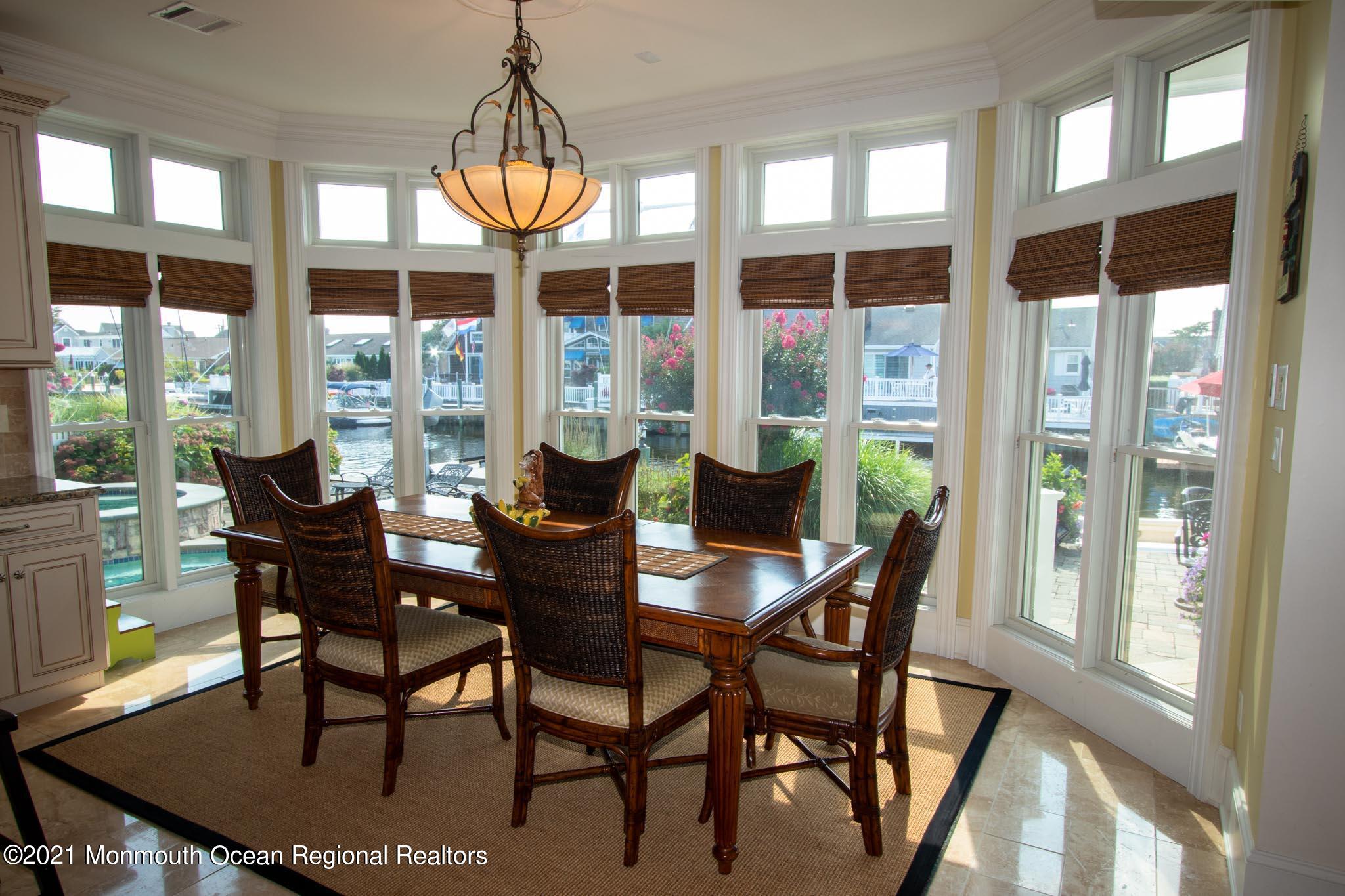 203 Ketch Road Mantoloking, NJ 08738 - Photo 28 of 88 a dining room with furniture a chandelier and wooden floor