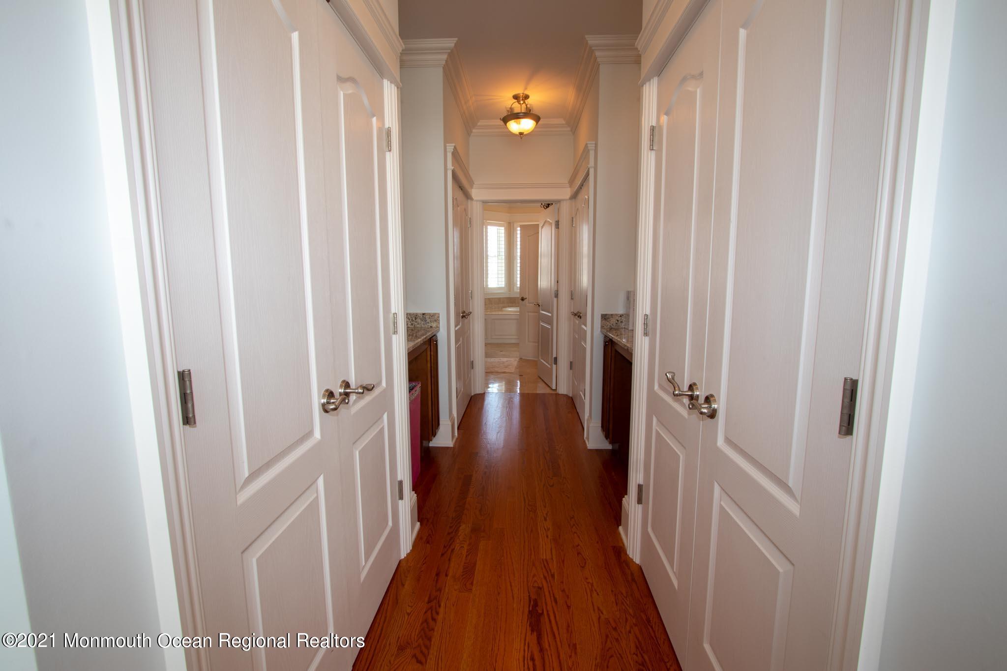 203 Ketch Road Mantoloking, NJ 08738 - Photo 42 of 88 a view of a hallway with wooden floor and staircase