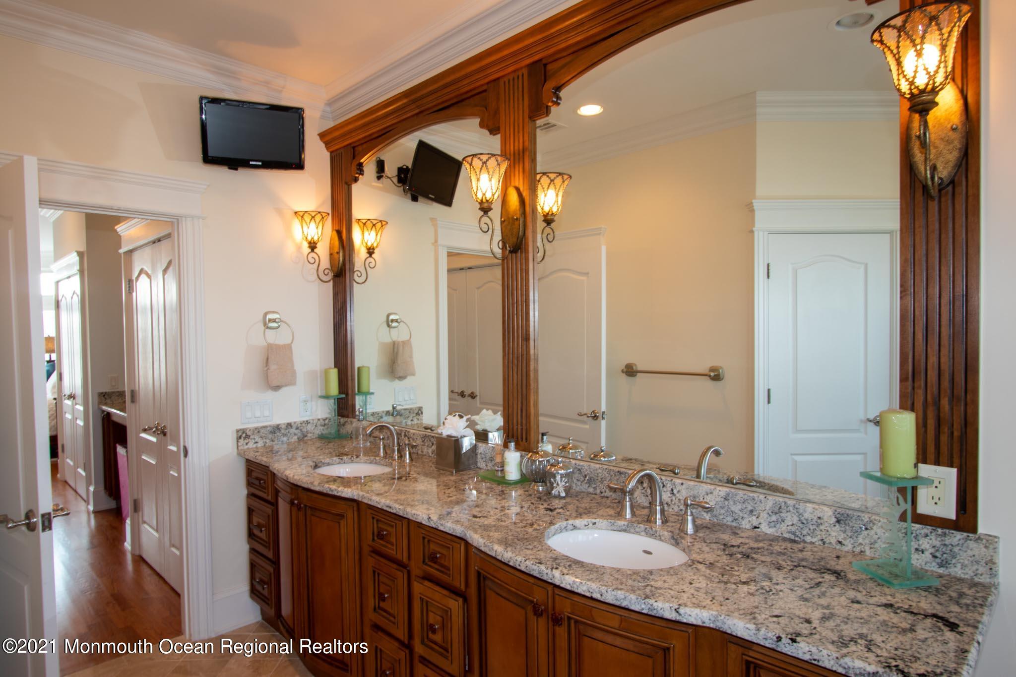 203 Ketch Road Mantoloking, NJ 08738 - Photo 43 of 88 a bathroom with a granite countertop sink and a mirror