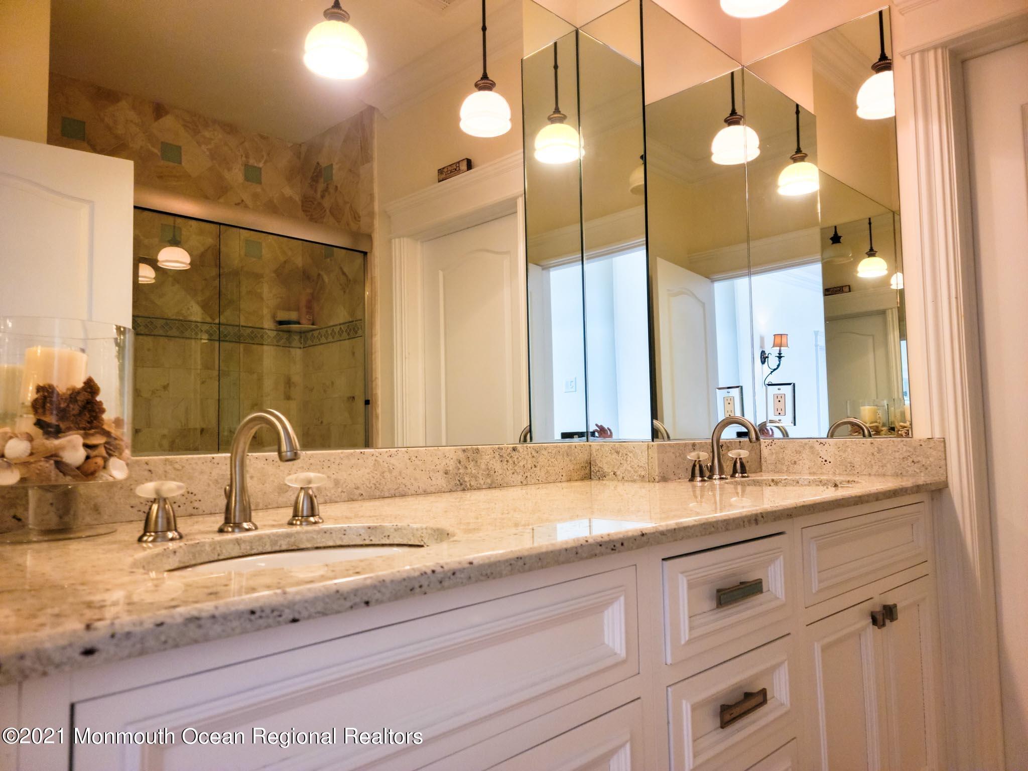 203 Ketch Road Mantoloking, NJ 08738 - Photo 46 of 88 a bathroom with a sink and a mirror
