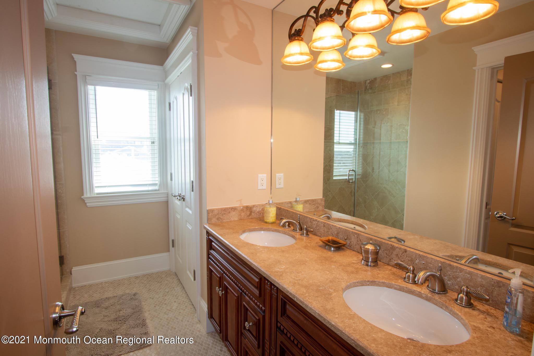 203 Ketch Road Mantoloking, NJ 08738 - Photo 65 of 88 a bathroom with a double vanity sink and a mirror