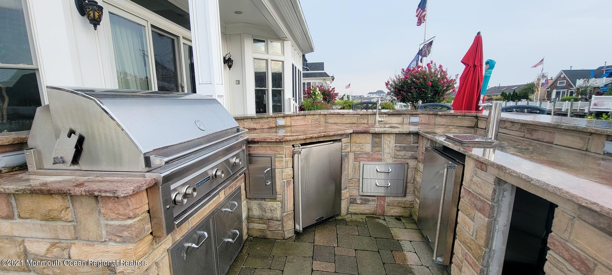 203 Ketch Road Mantoloking, NJ 08738 - Photo 75 of 88 a utility room with stainless steel appliances granite countertop furniture and a fireplace