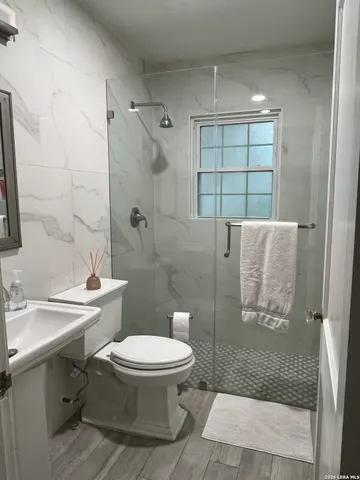a bathroom with a toilet sink and shower
