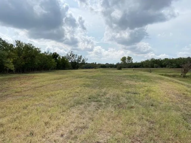 a view of a lake with houses in the back
