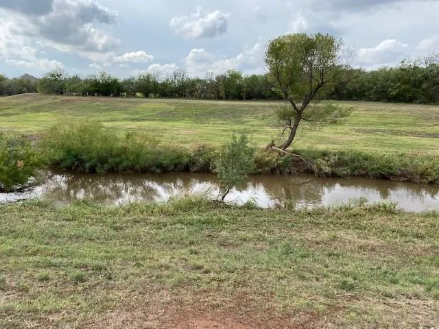 a view of a lake with houses in the back