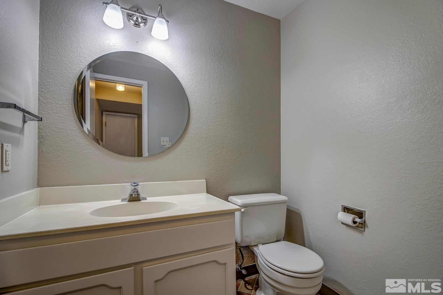 7513 Cumberland Circle Reno, NV 89511 - Photo 12 of 26 a bathroom with a toilet sink and mirror