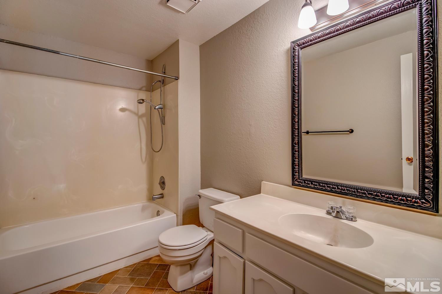 7513 Cumberland Circle Reno, NV 89511 - Photo 21 of 26 a bathroom with a sink a toilet and shower