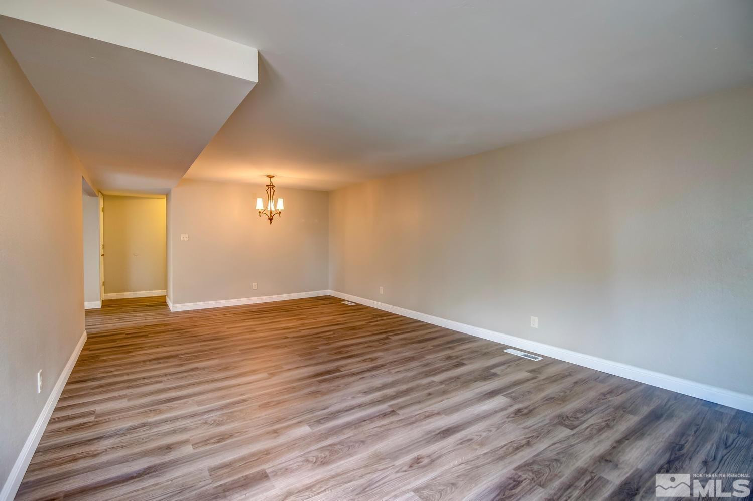 7513 Cumberland Circle Reno, NV 89511 - Photo 8 of 26 a view of empty room with wooden floor