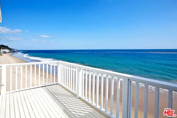 a view of a balcony with wooden floor