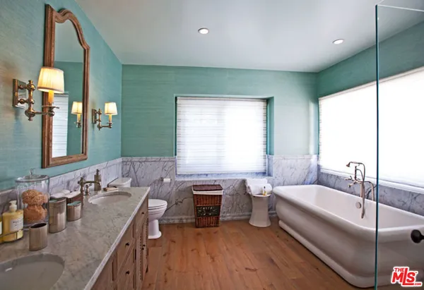 a spacious bathroom with a double vanity sink and a bathtub