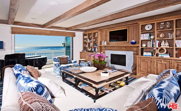 a living room with furniture fireplace and flat screen tv