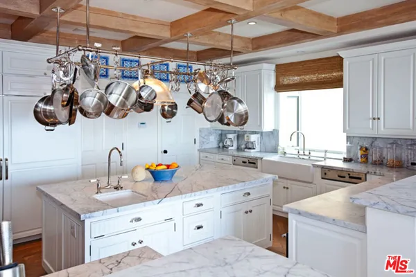 a kitchen with a sink a stove and cabinets