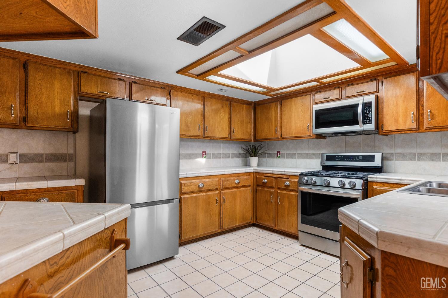 Undisclosed Address Tehachapi, CA 93561 - Photo 12 of 38 a kitchen with stainless steel appliances granite countertop a refrigerator stove top oven a sink and dishwasher
