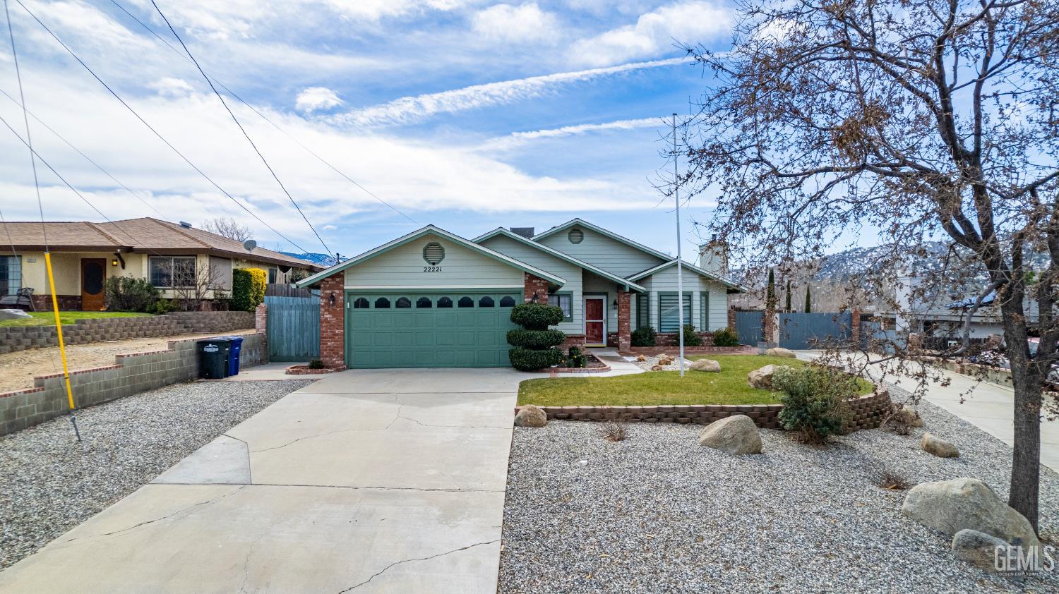 Undisclosed Address Tehachapi, CA 93561 - Photo 2 of 38 a front view of a house with garden and porch