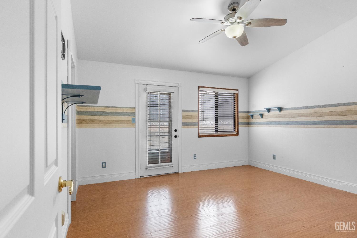 Undisclosed Address Tehachapi, CA 93561 - Photo 25 of 38 a view of empty room with wooden floor and ceiling fan