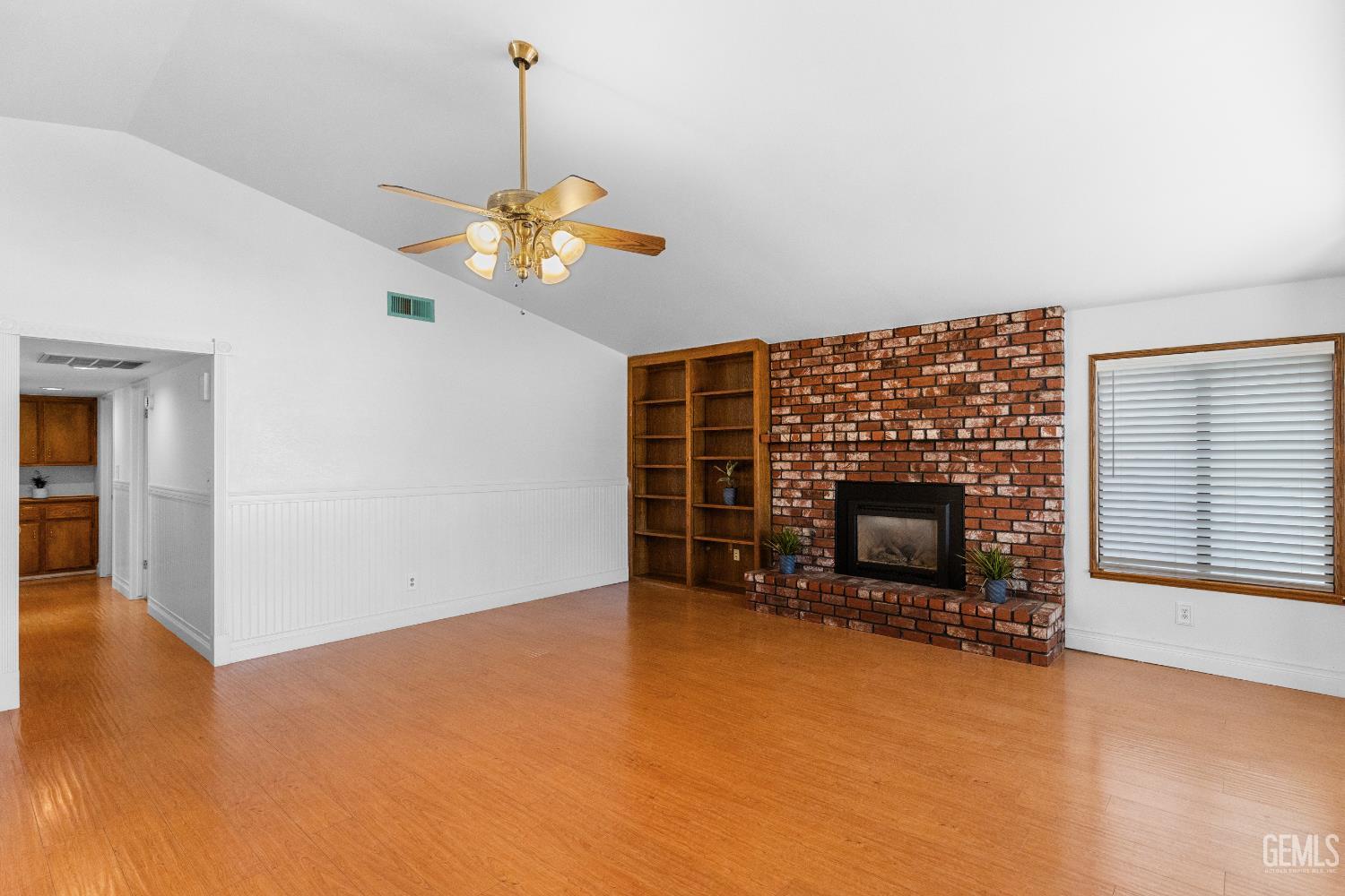 Undisclosed Address Tehachapi, CA 93561 - Photo 6 of 38 a view of a livingroom with a fireplace a chandelier and windows