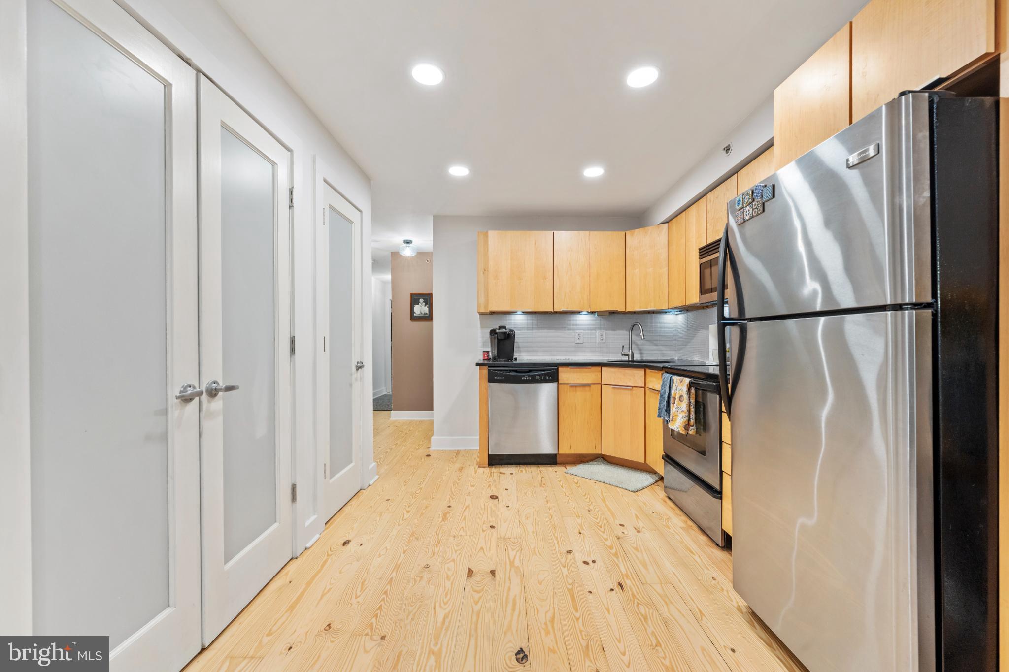 2123 Christian Street, Unit A Philadelphia, PA 19146 - Photo 4 of 15 a kitchen with a refrigerator a sink and cabinets