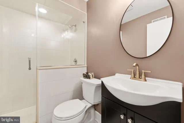 a bathroom with a sink a mirror and a toilet