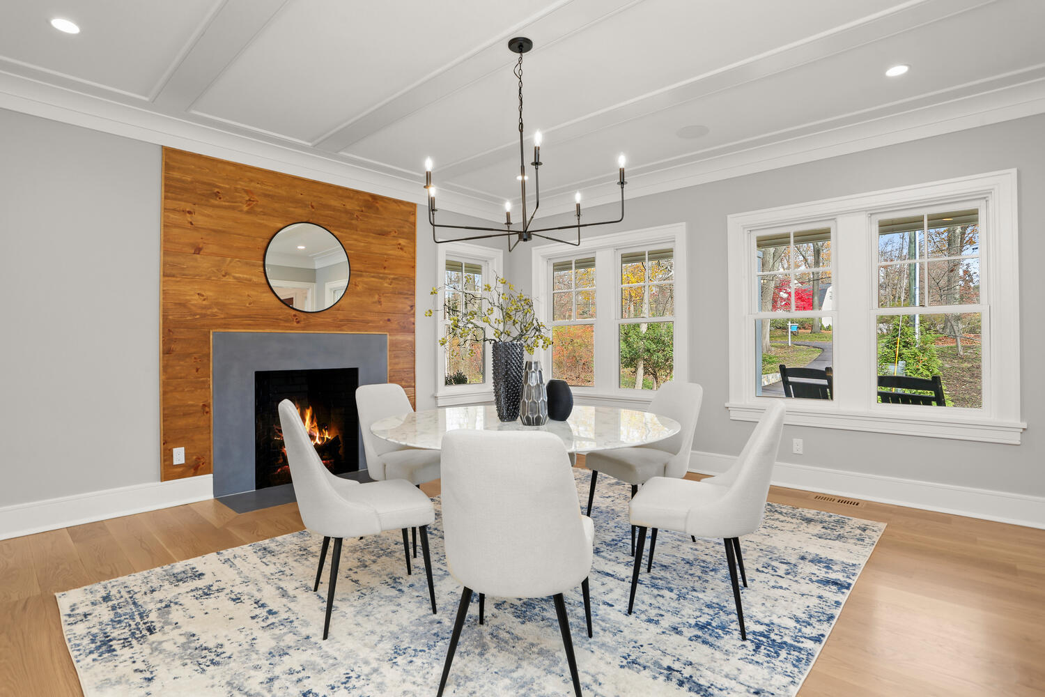24 Country Club Road New Canaan, CT 06840 - Photo 25 of 43 a dining room with furniture wooden floor a rug and a chandelier