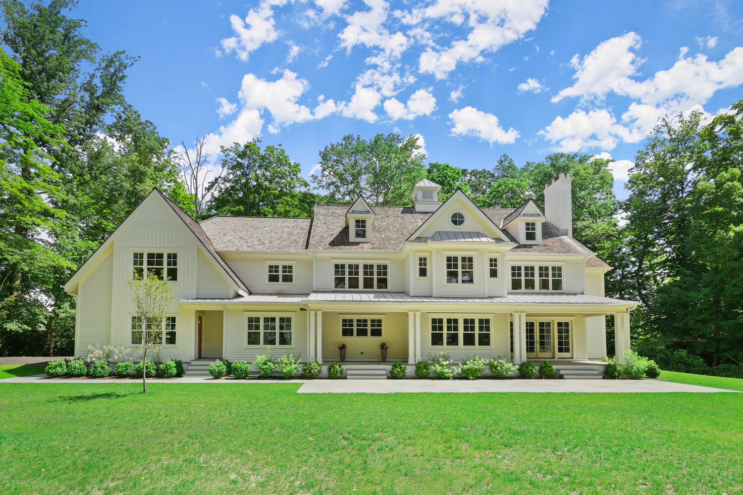 24 Country Club Road New Canaan, CT 06840 - Photo 3 of 43 a front view of a house with a garden