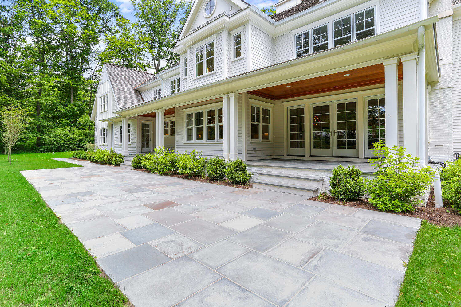 24 Country Club Road New Canaan, CT 06840 - Photo 41 of 43 a front view of a house with garden and plants