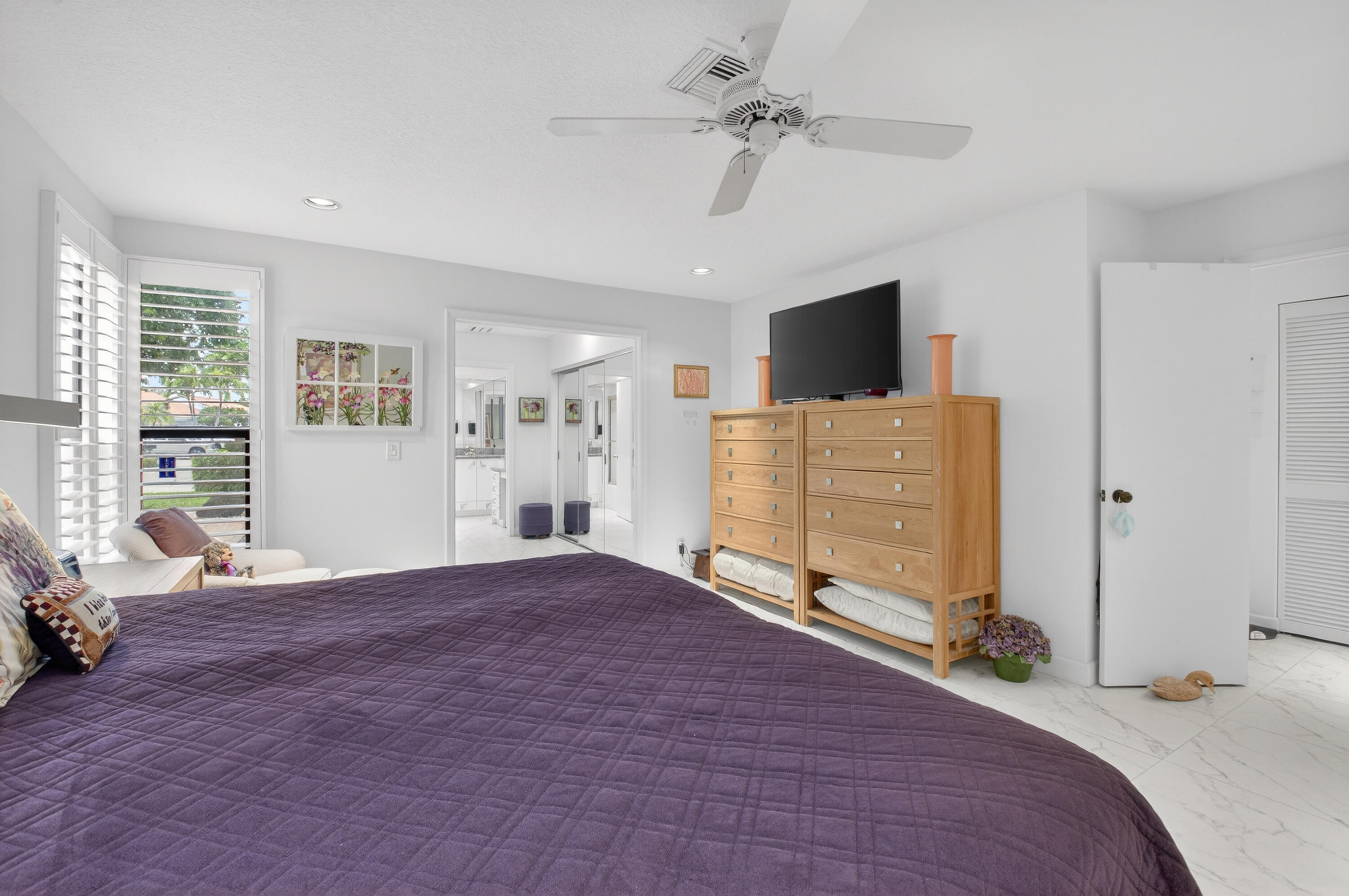 19620 Sawgrass Circle, Unit 2802 Boca Raton, FL 33434 - Photo 18 of 79 a bedroom with a bed and a flat screen tv