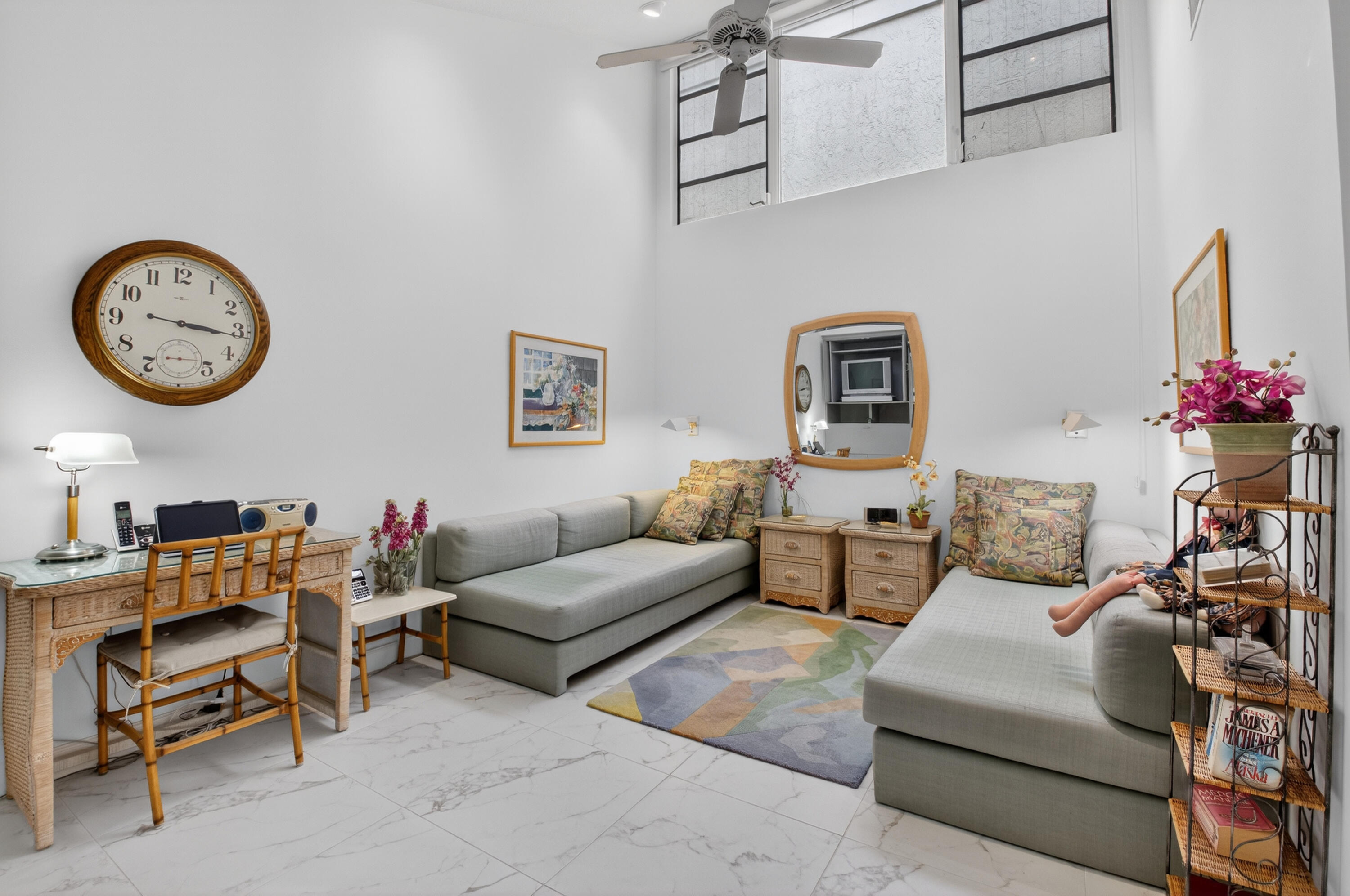 19620 Sawgrass Circle, Unit 2802 Boca Raton, FL 33434 - Photo 24 of 79 a living room with furniture a clock and a large window
