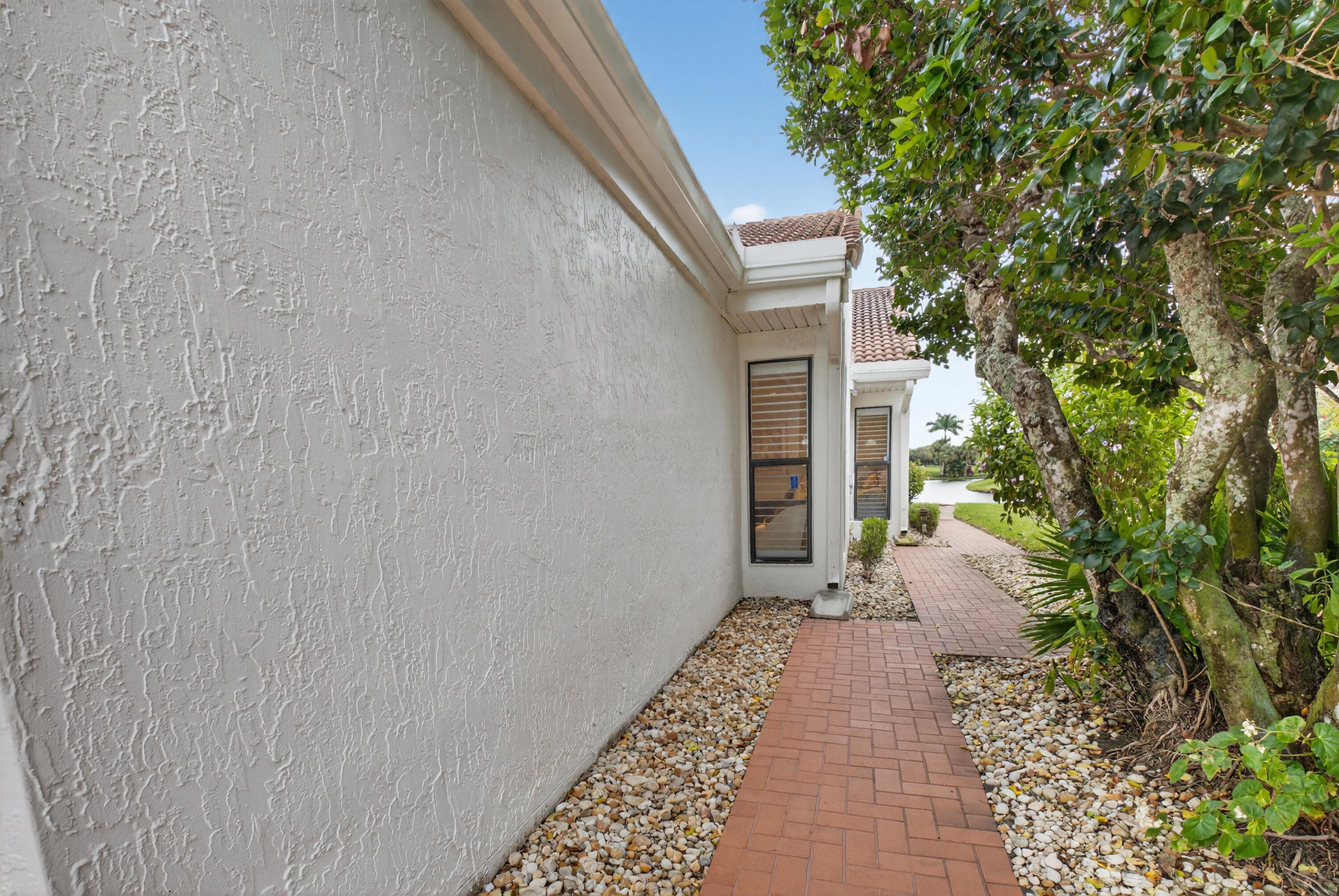 19620 Sawgrass Circle, Unit 2802 Boca Raton, FL 33434 - Photo 28 of 79 a view of a pathway with a white house