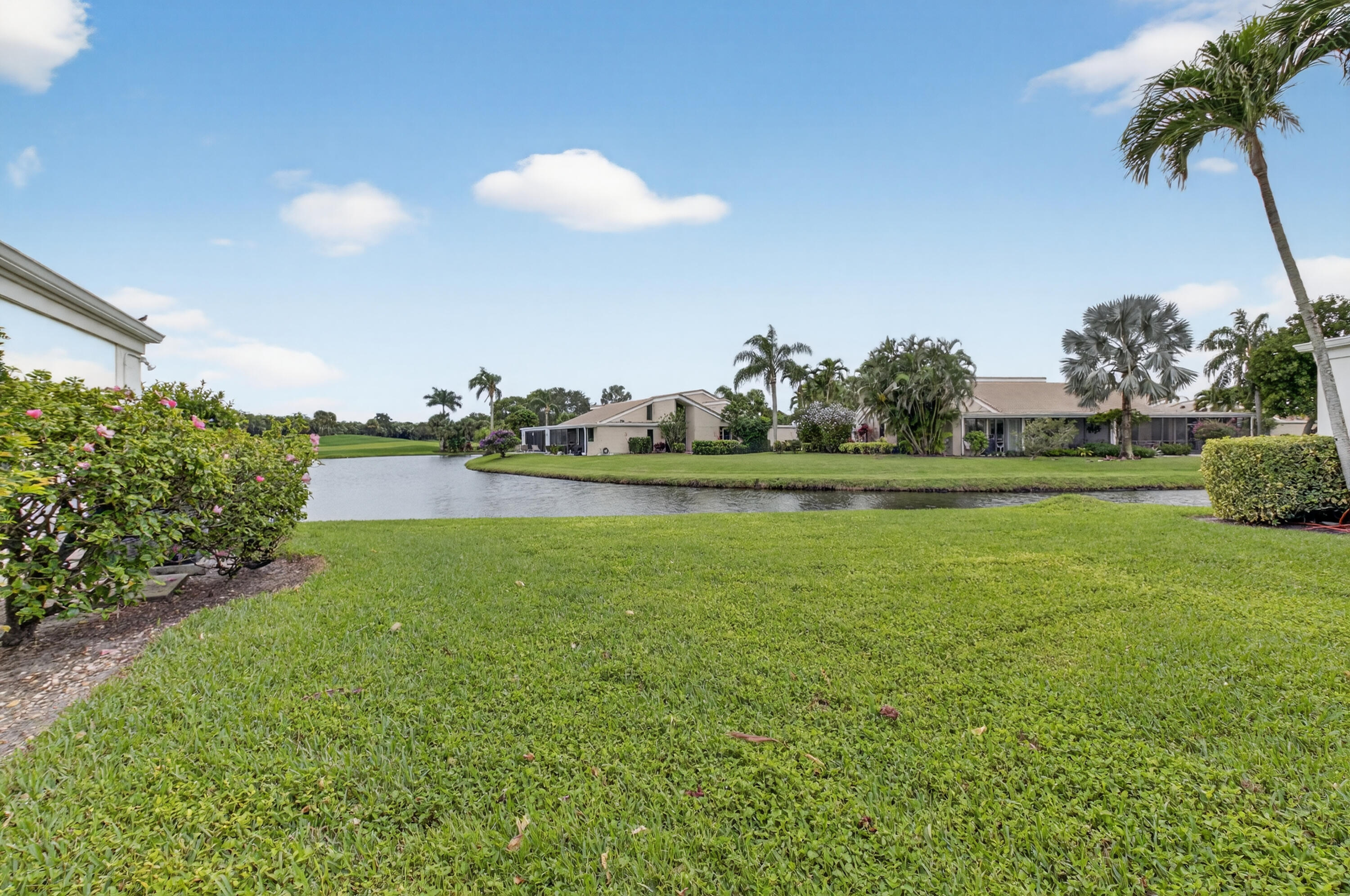 19620 Sawgrass Circle, Unit 2802 Boca Raton, FL 33434 - Photo 30 of 79 a view of a golf course with a lake