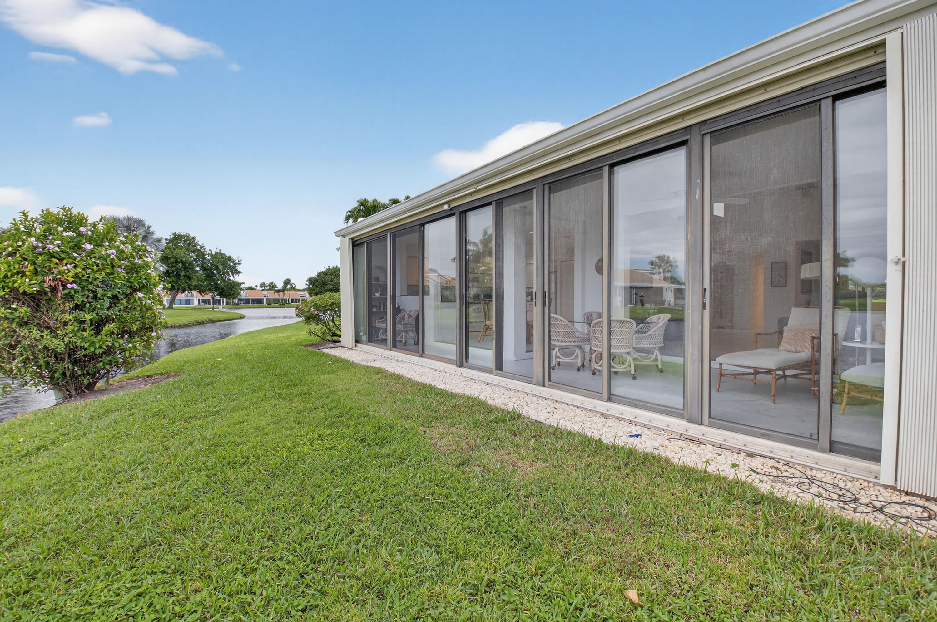 19620 Sawgrass Circle, Unit 2802 Boca Raton, FL 33434 - Photo 34 of 79 a view of a backyard with plants and large trees