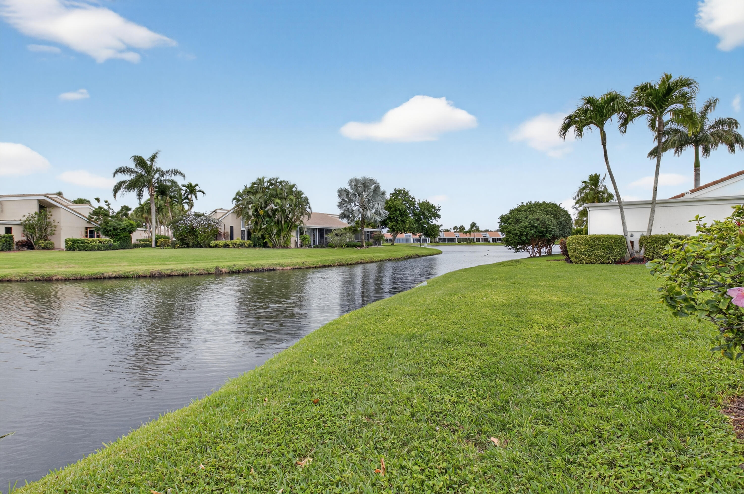 19620 Sawgrass Circle, Unit 2802 Boca Raton, FL 33434 - Photo 37 of 79 a view of a lake with a yard