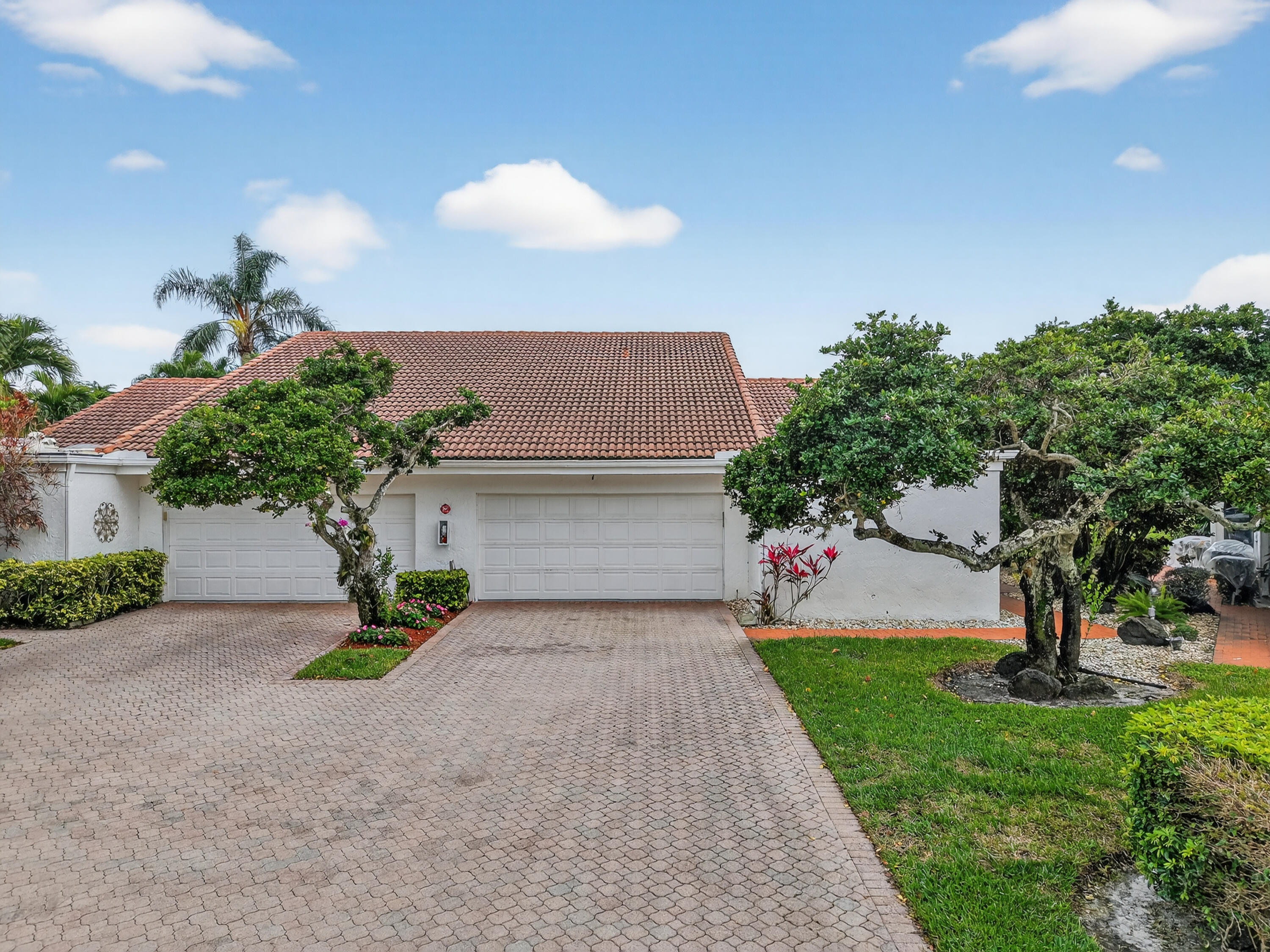 19620 Sawgrass Circle, Unit 2802 Boca Raton, FL 33434 - Photo 38 of 79 a view of a house with a yard and a garage