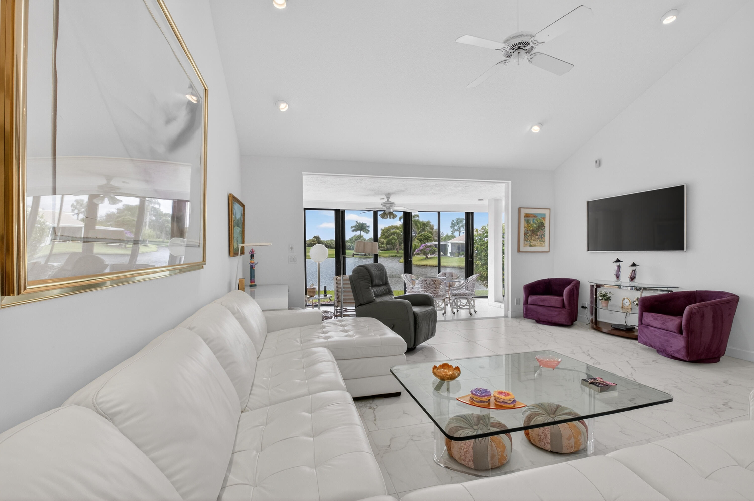19620 Sawgrass Circle, Unit 2802 Boca Raton, FL 33434 - Photo 8 of 79 a living room with furniture a flat screen tv and a large window