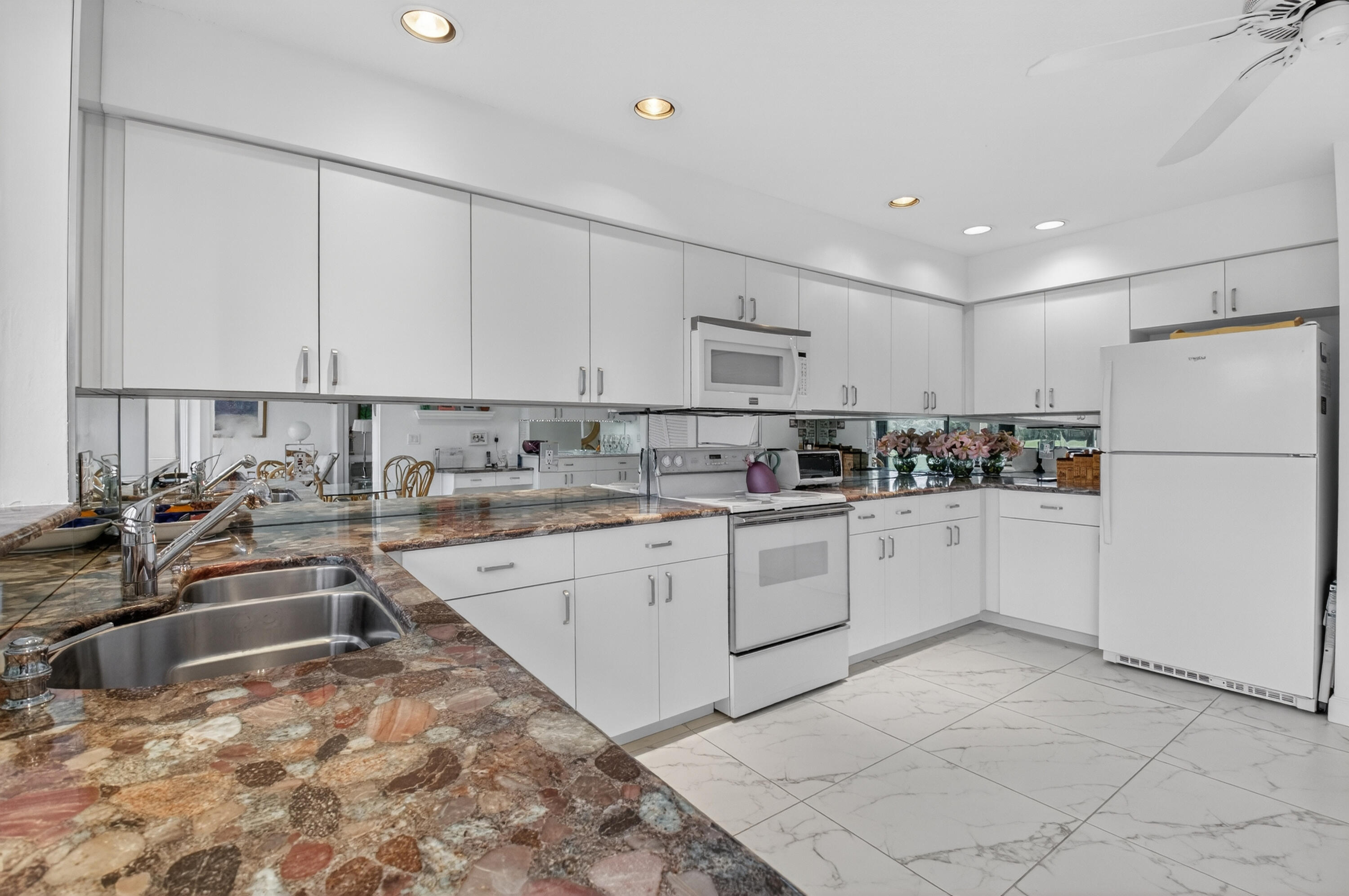 19620 Sawgrass Circle, Unit 2802 Boca Raton, FL 33434 - Photo 9 of 79 a kitchen with granite countertop a sink stainless steel appliances and cabinets