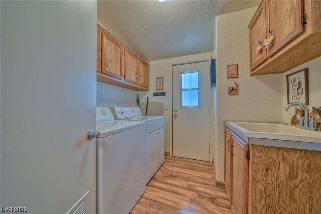 3981 North Blagg Road Pahrump, NV 89060 - Photo 20 of 31 Laundry room with sink and plenty of cupboards.