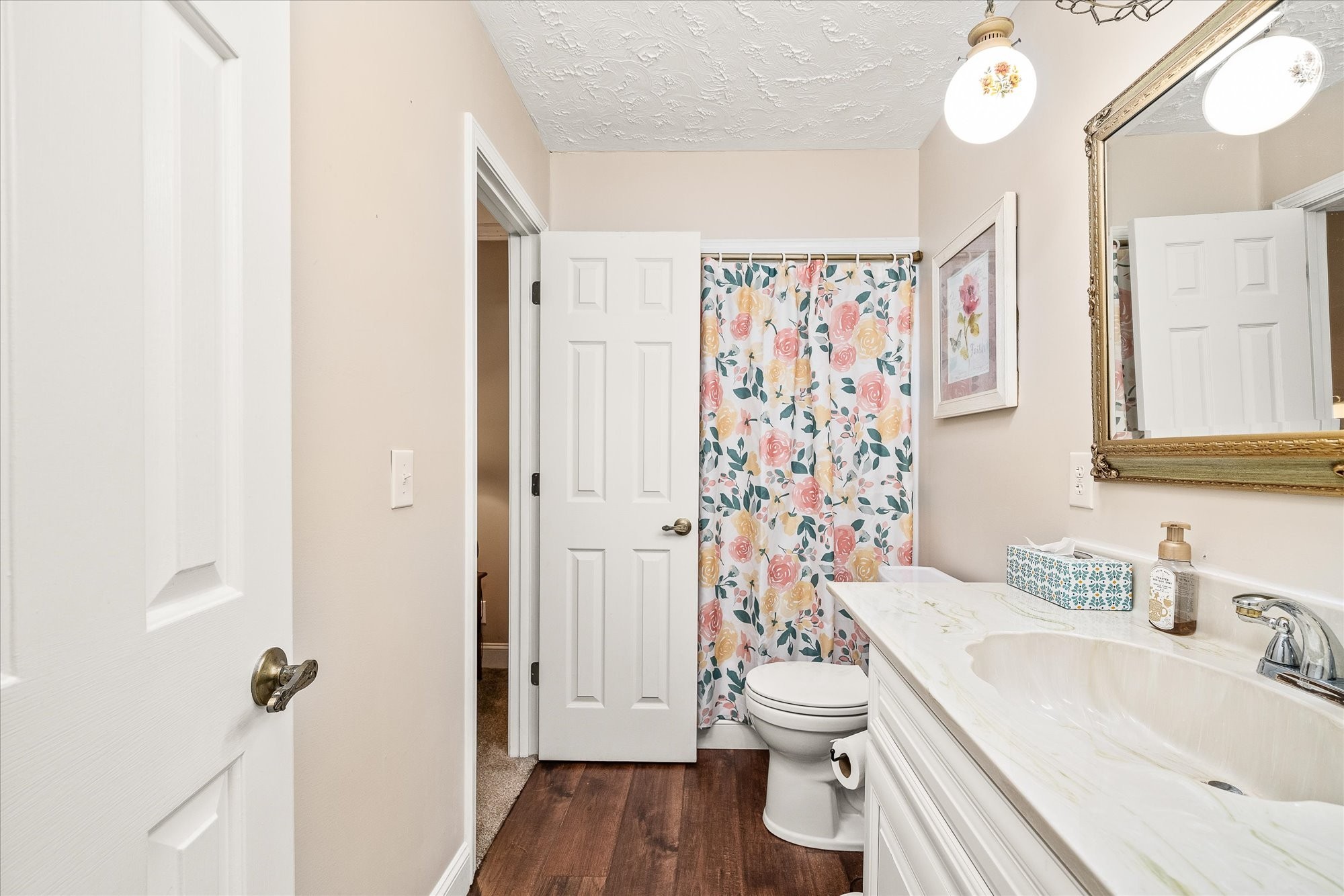 221 Magnolia Road Sparta, TN 38583 - Photo 15 of 36 a bathroom with a sink a toilet and shower curtain