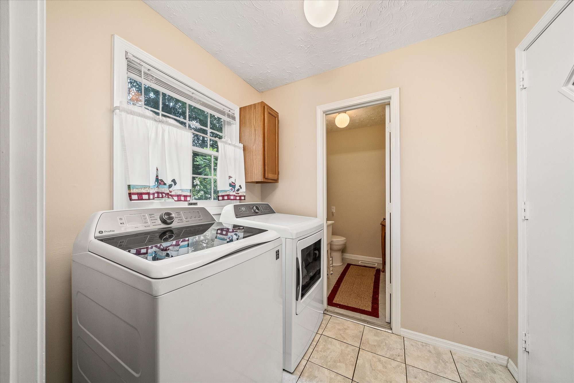221 Magnolia Road Sparta, TN 38583 - Photo 19 of 36 a bathroom with a sink and a washing machine