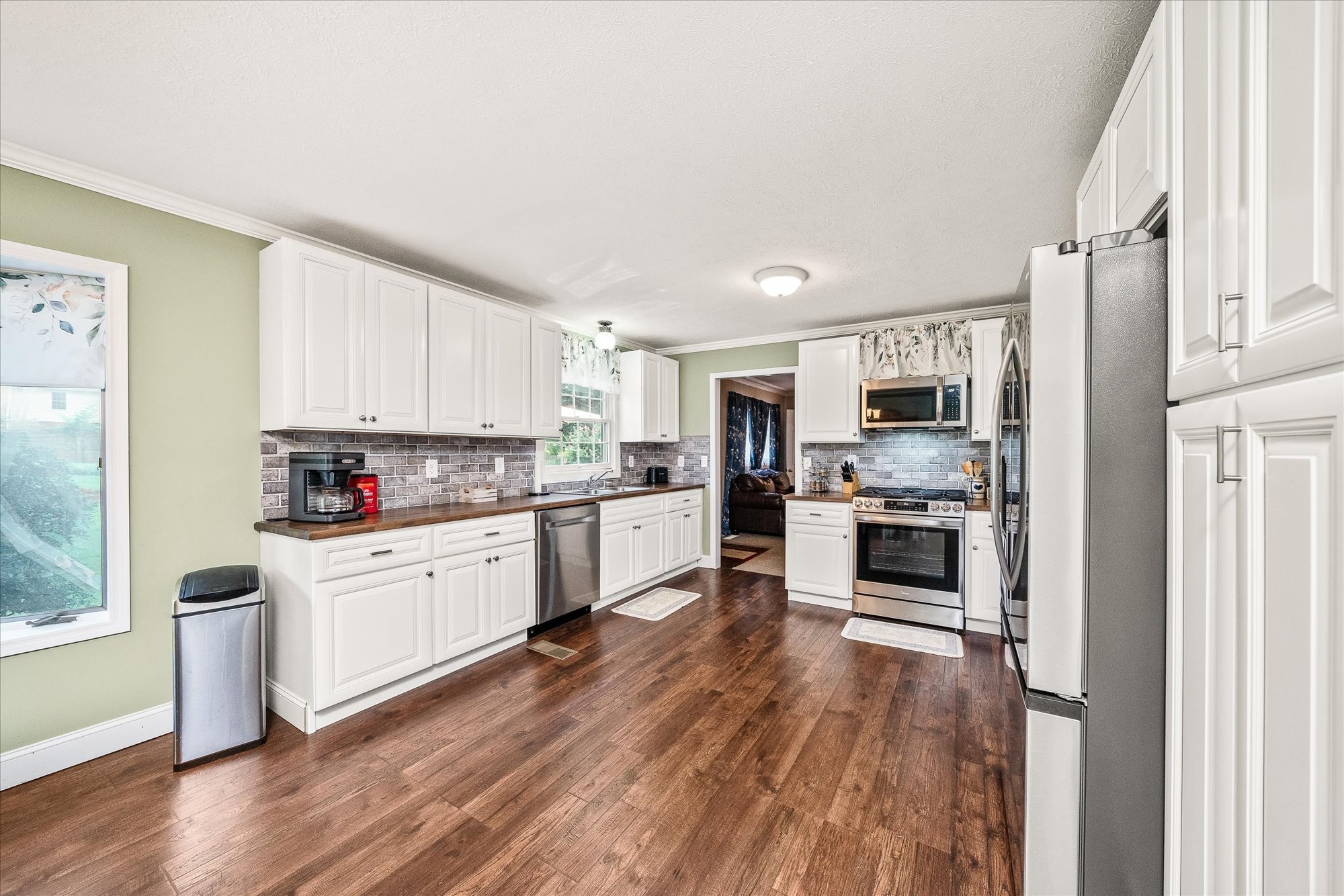 221 Magnolia Road Sparta, TN 38583 - Photo 6 of 36 a kitchen with white cabinets and stainless steel appliances