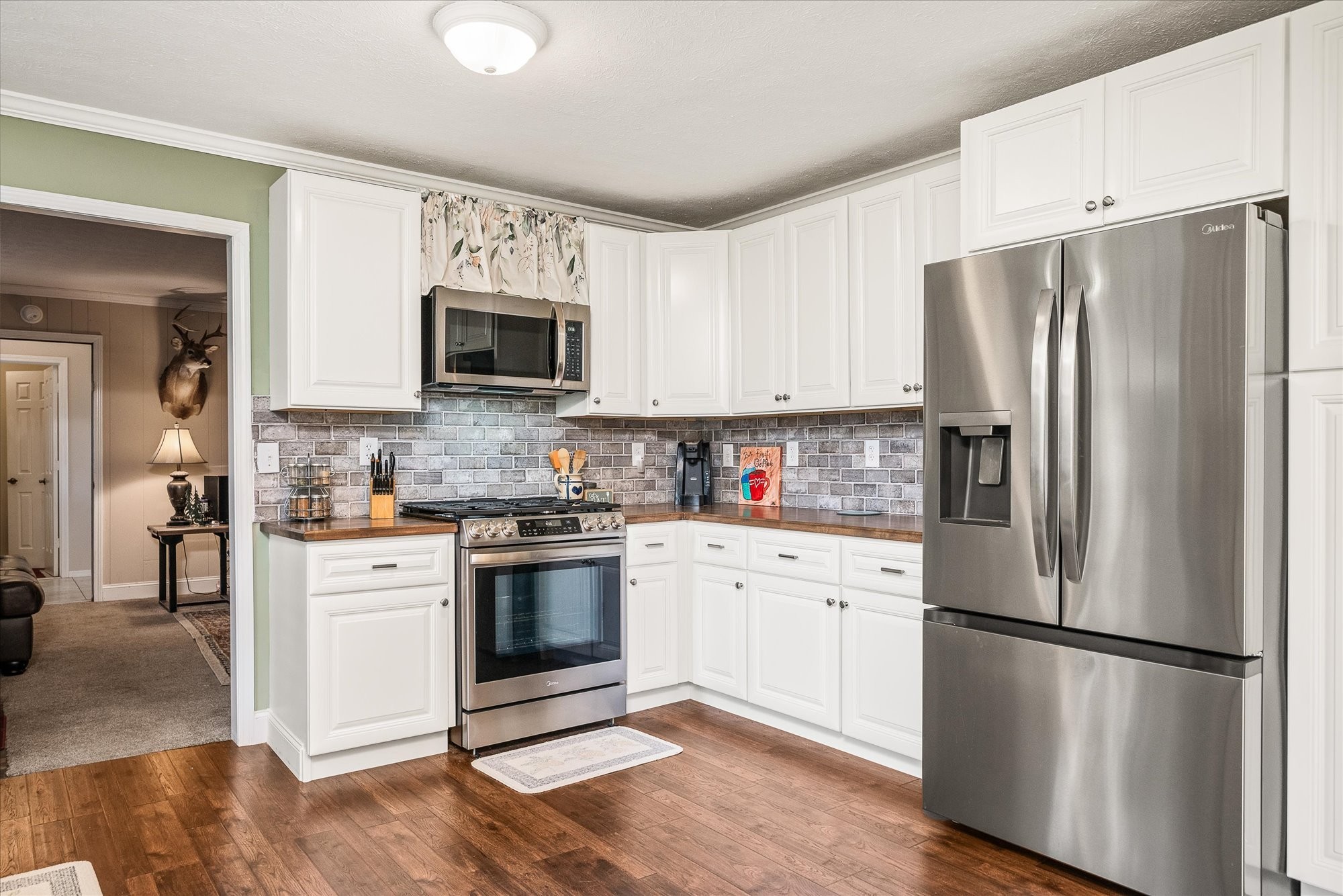221 Magnolia Road Sparta, TN 38583 - Photo 7 of 36 a kitchen with a refrigerator stove and microwave