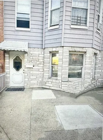a view of a brick house with many windows