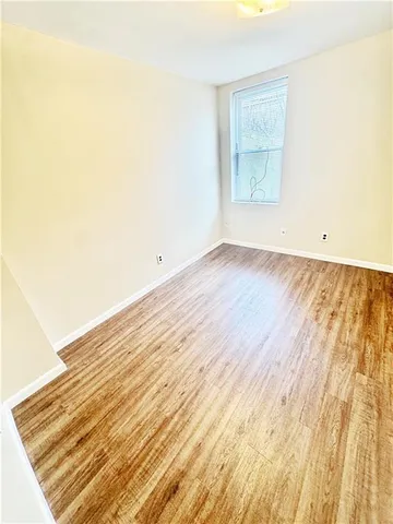 a view of an empty room and wooden floor