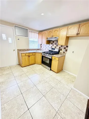a large kitchen with a stove a sink dishwasher and a refrigerator