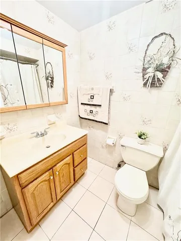 a bathroom with a sink mirror vanity and toilet