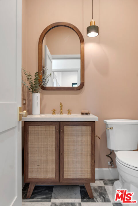 3617 Hillcrest Drive Los Angeles, CA 90016 - Photo 13 of 34 a bathroom with a sink a toilet and a mirror