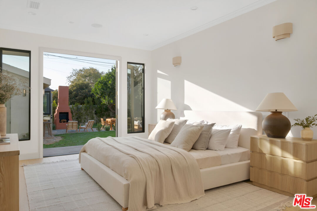 3617 Hillcrest Drive Los Angeles, CA 90016 - Photo 18 of 34 a bedroom with a bed and large windows